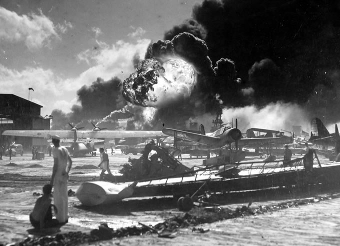 Ford-Island-Pearl-Harbor-Attack-20 a group of people on a boat with Pearl Harbor in the background