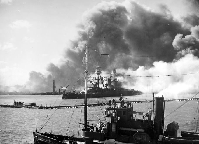 USS-Nevada-Pearl-Harbor-History-06 a steam boat on a body of water with smoke coming out of it