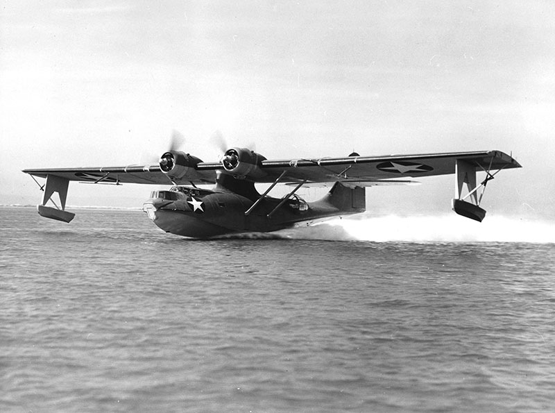 Pearl-Harbor-Catalina-Plane a small airplane sitting on top of a body of water