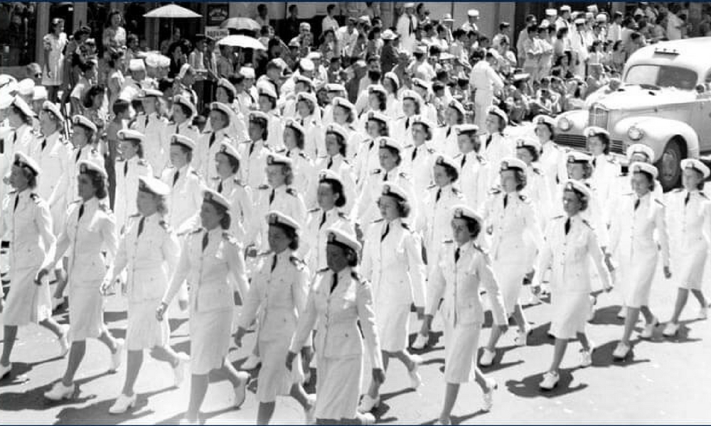 Nurses-At-Pearl-Harbor a group of people walking in front of a crowd