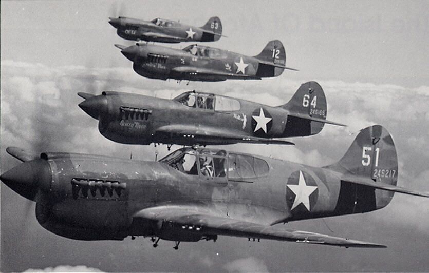 ww2-movies a vintage photo of a propeller plane that is flying in the air